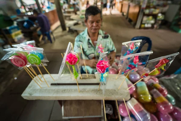 stock image Bangkok, Thailand - April, 16, 2023 : Molding traditional art candy from sugar with food colorant at Taling Chan Floating Markett at Bangkok, Thailand.