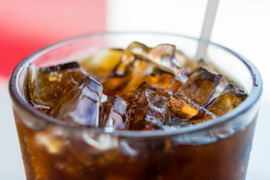 Close-up view of a glass of iced soda on the table in restuarant clipart