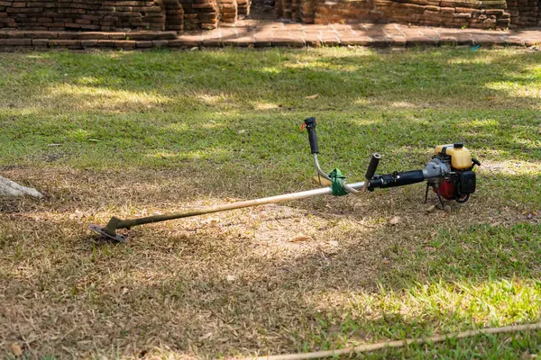 stock image Lawn mower on a green lawn