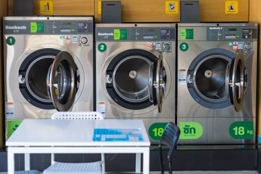 Bangkok, Tayland - 08 Haziran 2024: Bangkok Tayland 'da bir çamaşırhanede bir dizi ticari çamaşır makinesi.
