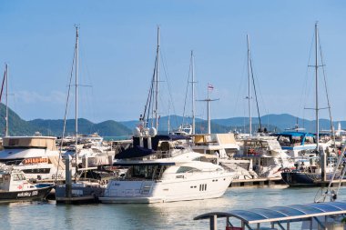 Chonburi, Thailand - May, 27, 2024 : Luxury Yachts and Boats Docked at a Scenic Marina with Mountain Views at Chonburi, Thailand clipart