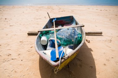 Chonburi, Thailand - May, 27, 2024 :Beachside Serenity: A Rustic Fishing Boat Basking in the Sun at Chonburi, Thailand clipart