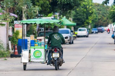 Nonthaburii, Thailand - June, 24, 2024 : Street Food Vendor on the Move: A Mobile Culinary Experience at Nonthaburii, Thailand. clipart