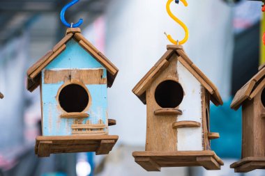 Beautifully made wooden birdhouses hanging outdoors, ideal for nature lovers. clipart