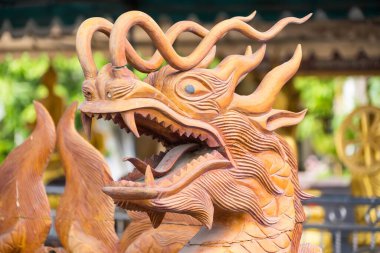 Samut Prakan, Thailand - June, 12, 2024 :Magnificent Dragon Wood Sculpture in a Thai Temple at Samut Prakan, Thailand. clipart