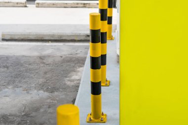 The vivid yellow and black safety posts are designed to grab attention and enhance safety awareness among customers. clipart