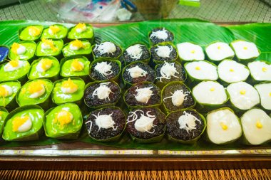 An enticing display of traditional Thai desserts in a local market, capturing the beauty of Thai sweet treats. clipart