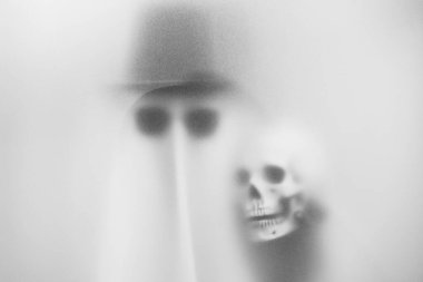 Spooky Ghost in Sunglasses and Skull Amidst Mist  Haunting Art for Halloween and Mysterious Themes at Bangkok, Thailand. clipart