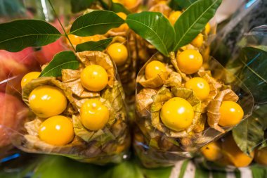 Fresh cape gooseberries are displayed in a Thai market, known for their benefits in cancer prevention and heart health. clipart