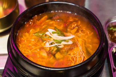 Embark on a culinary adventure with this Korean spicy soup, featuring a medley of flavors and textures that will tantalize your palate. clipart