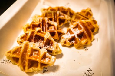 Delicious waffles topped with powdered sugar, perfect for breakfast. clipart