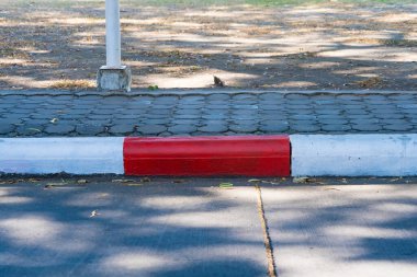 Red and White Painted Curb Indicating a No Parking Zone for Better Traffic Management and Pedestrian Safety in City Streets clipart