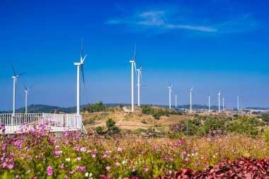 Phetchabun, Thailand - January, 06, 2025 : Panoramic View of Wind Turbines in a Scenic Countryside Landscape with Clear Blue Skies at Phetchabun, Thailand. clipart