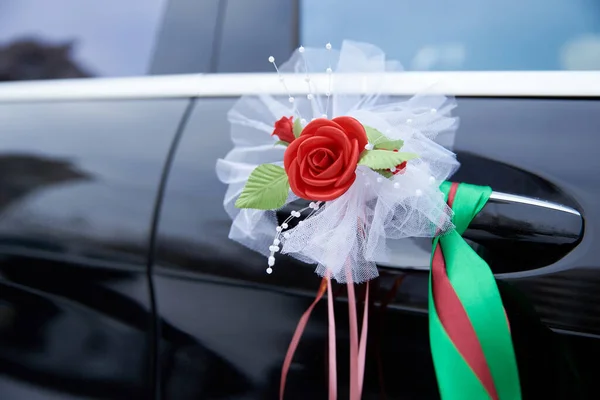 Decoration red rose on a black wedding car