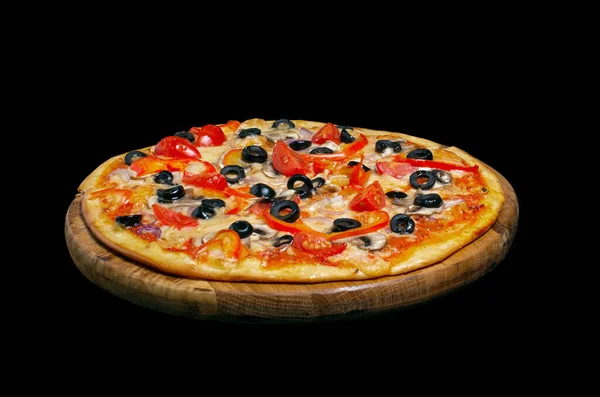 Vegetarian pizza, on a wooden kitchen board. Isolated on black background