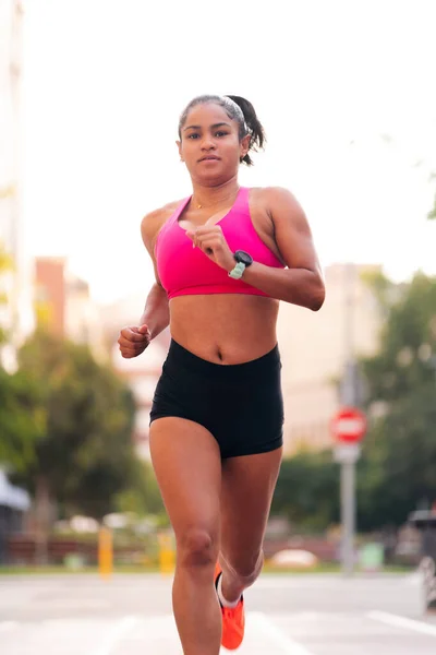 stock image female athlete running during her training at the city, urban sport and healthy lifestyle concept, copy space for text