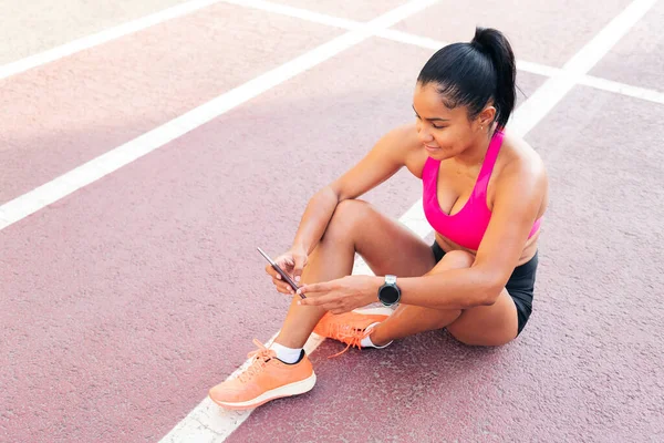 Atleta Feminina Usando Seu Telefone Celular Sentado Pista Atletismo Após — Fotografia de Stock