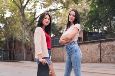 two young women posing happy and smiling looking at camera, concept of female friendship and teenager lifestyle