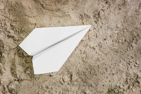 White paper plane close-up. Airplane folded from paper. High quality photo