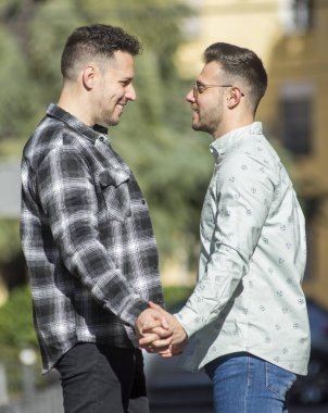 A portrait of happy gay couple outdoors