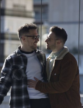 A portrait of happy gay couple outdoors