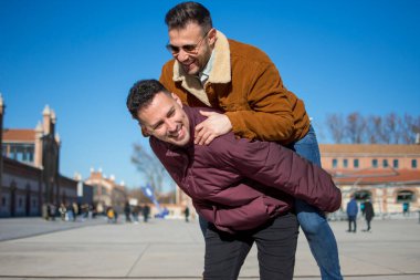 A portrait of happy gay couple outdoors