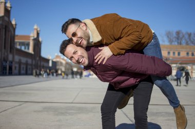 A portrait of happy gay couple outdoors