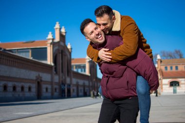 A portrait of happy gay couple outdoors