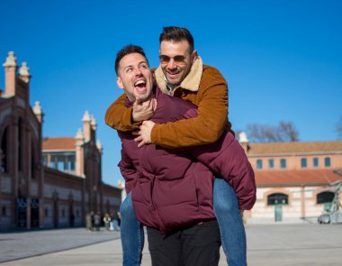 A portrait of happy gay couple outdoors