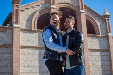 A portrait of happy gay couple outdoors
