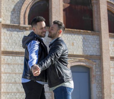 A portrait of happy gay couple outdoors