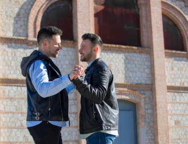 A portrait of happy gay couple outdoors