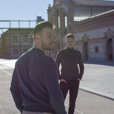 A portrait of happy gay couple outdoors