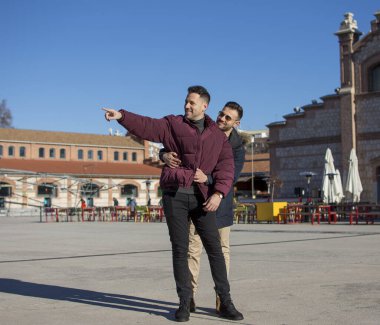 A portrait of happy gay couple outdoors