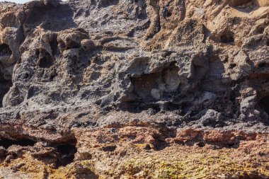 Landscape of sand and volcanic mountains with caves in the canary islands
