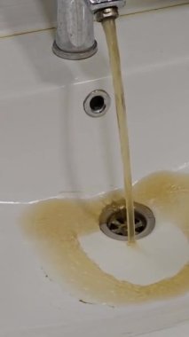 Kirli su musluktan lavaboya akar. Dairede içme suyu kirliliği bir sorundur. Musluk suyunun kirlenmesi.