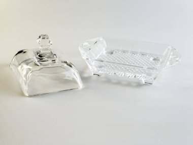 Beyaz arkaplanda tereyağı depolamak için cam kap.