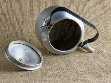 2. Dünya Savaşı 'ndan kalma açık kapaklı alüminyum ordu çaydanlığı. İçeriden bak. Sovyet askerinin çaydanlığı. Yakın plan. Çuval bezi arka planı.