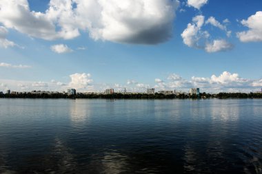 Dinyeper Nehri 'nin sol kıyısının panoramik manzarası. Ukrayna. Dinyeper şehri. Su yüzeyinde bulutlu gökyüzünün yansıması..