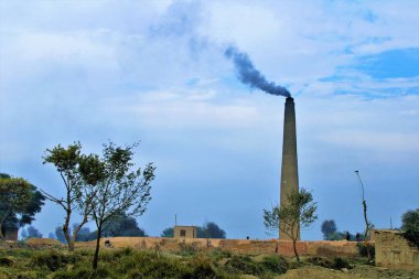 A brick kiln with black smoke, spreading smog, a black carbon in the area, Pakistan.
