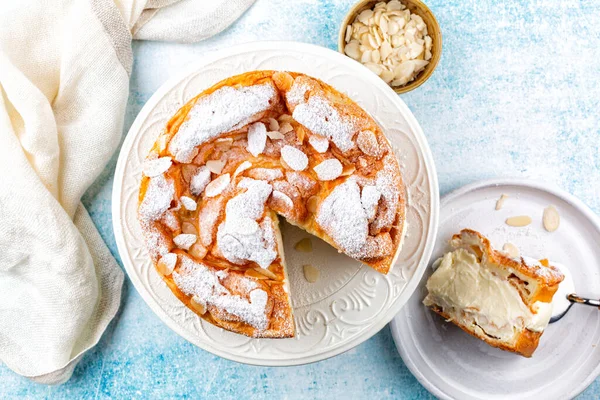 Cream puff cake Karpatka. Polish Carpathian mountain custard , sandwich, cream cake that consists of two layers of choux pastry and delicious pastry with almonds and powdered sugar, top view.