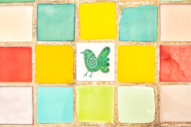 Pastel renkler kare desen arkaplan, teneke kaplı fayanslar, orta kısımda kuş resmi