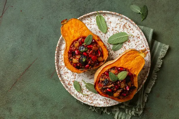 stock image Roast stuffed pumpkin with lentil, eggplant, tomato, onion and pomegranat. Oven baked vegetables, vegetarian or vegan food. Top view.