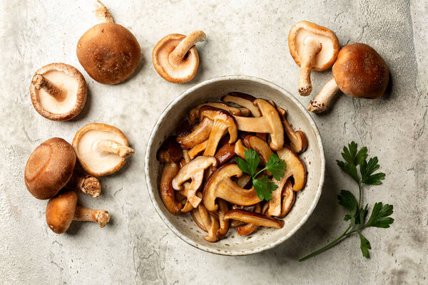 Fresh and fried with garlic oak mushroom. The shiitake or black forest mushrooms is an edible mushroom native to East Asia.