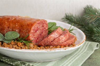 Italian Festive New  Year meal. Traditional cotechino con lenticchie or pork sausage with Lentils cooked with vegetables.  clipart