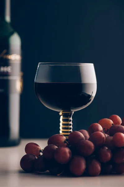Glas Rode Wijn Met Rode Druiven Buurt Donkerblauwe Achtergrond — Stockfoto