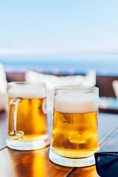 Glasses of cold craft light beer in open bar during summer vacation