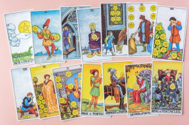 London, UK: 6 January, 2023: Minor Arcana - Suit of Pentacles of Tarot Card of Rider Waite deck on pink background clipart