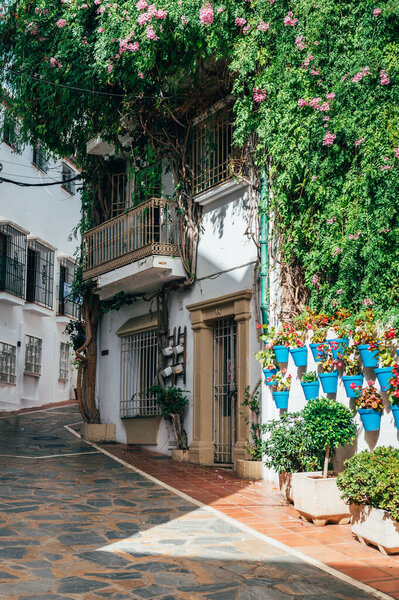 Marbella, Malaga, Spain - November 4, 2023: City streets of Marbella in Costa del Sol, Spain. The Old Town, iconic streets in Marbella and major tourist attractions with shops and bars at city centre