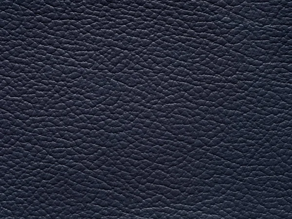 Luxury blue leather texture sample. Background with copy space, top view. Genuine leather pattern in dark tone. Faux eco leather. Backdrop textured effect for design, clothing, upholstered furniture.